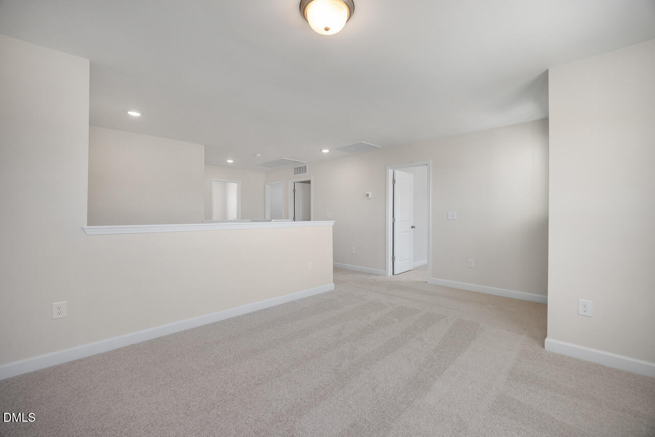 233 Tenure Lane Lillington, NC 27546 - Photo 16 of 30 a view of an empty room with kitchen and window