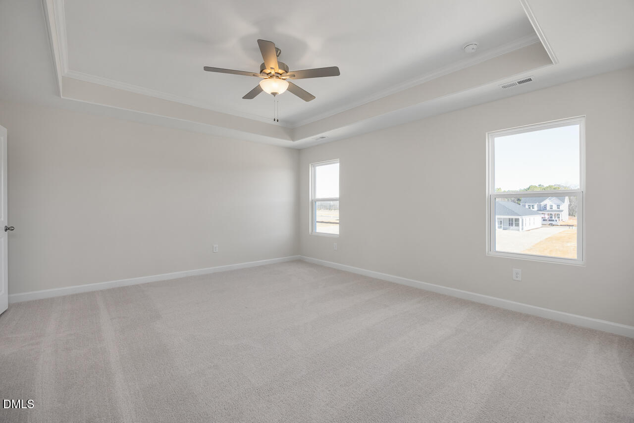 233 Tenure Lane Lillington, NC 27546 - Photo 17 of 30 an empty room with windows and fan