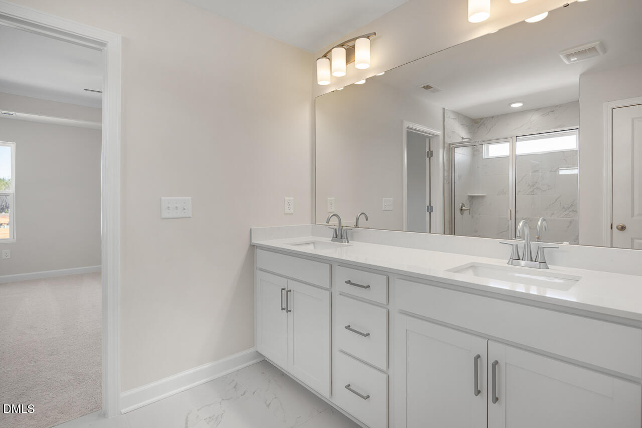 233 Tenure Lane Lillington, NC 27546 - Photo 20 of 30 a bathroom with a double vanity sink mirror and double
