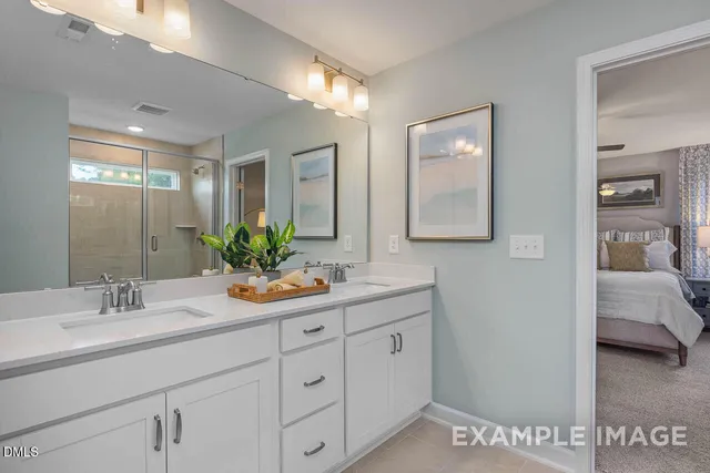 a bathroom with a double vanity sink and mirror with shower