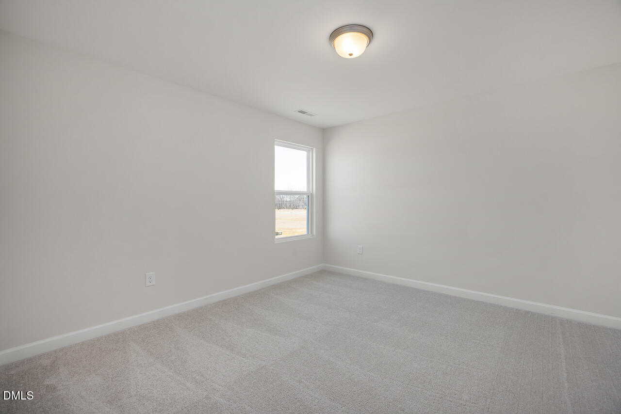 233 Tenure Lane Lillington, NC 27546 - Photo 23 of 30 an empty room with a window