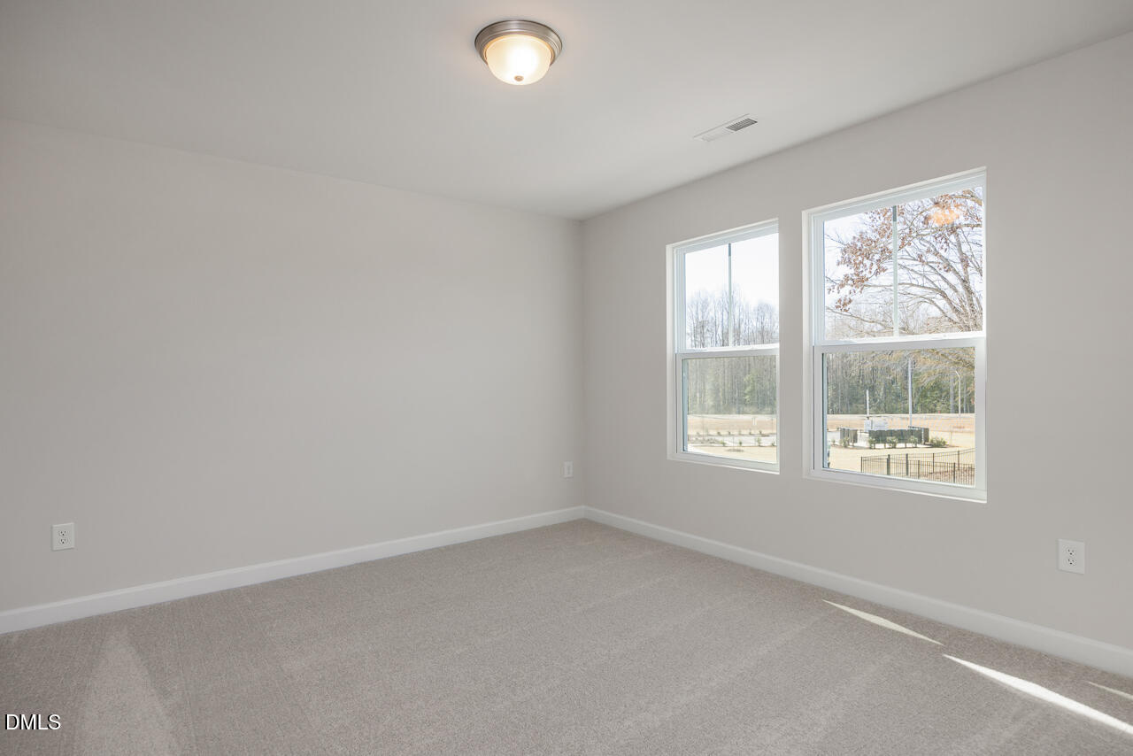233 Tenure Lane Lillington, NC 27546 - Photo 24 of 30 an empty room with a window