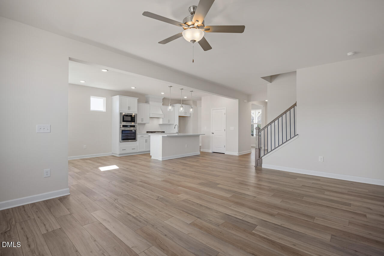 233 Tenure Lane Lillington, NC 27546 - Photo 7 of 30 a view of empty room with wooden floor and fan