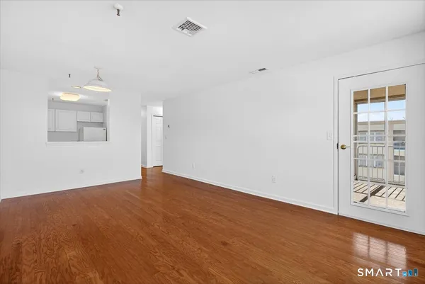 wooden floor in an empty room with a window