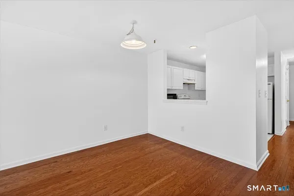 a view of a room with wooden floor and window