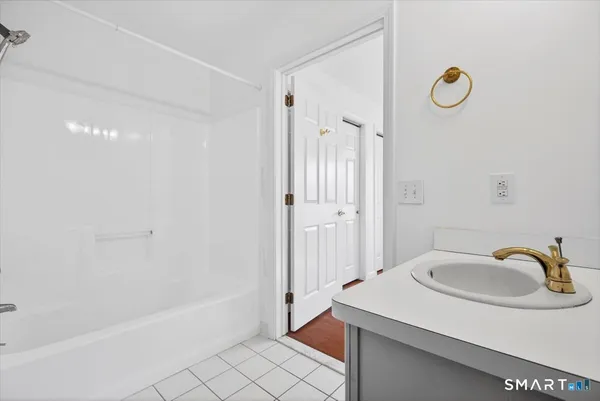 a bathroom with a sink a tub and a shower