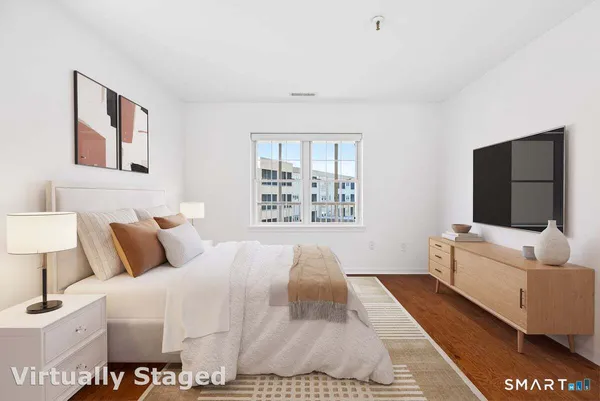 a bedroom with a large bed and a flat screen tv