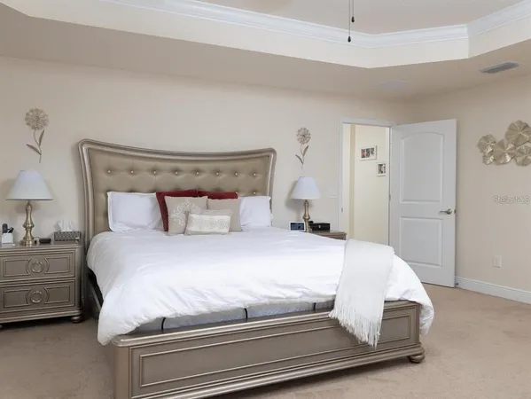 a bedroom with a bed and a lamp