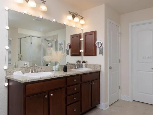 a bathroom with a double vanity sink and a mirror