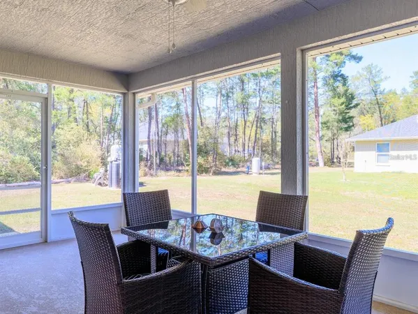 a view of a dining room with furniture and window