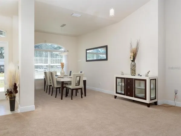a dining room with furniture and window