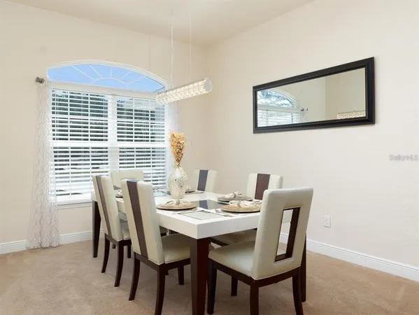a view of a dining room with furniture and window