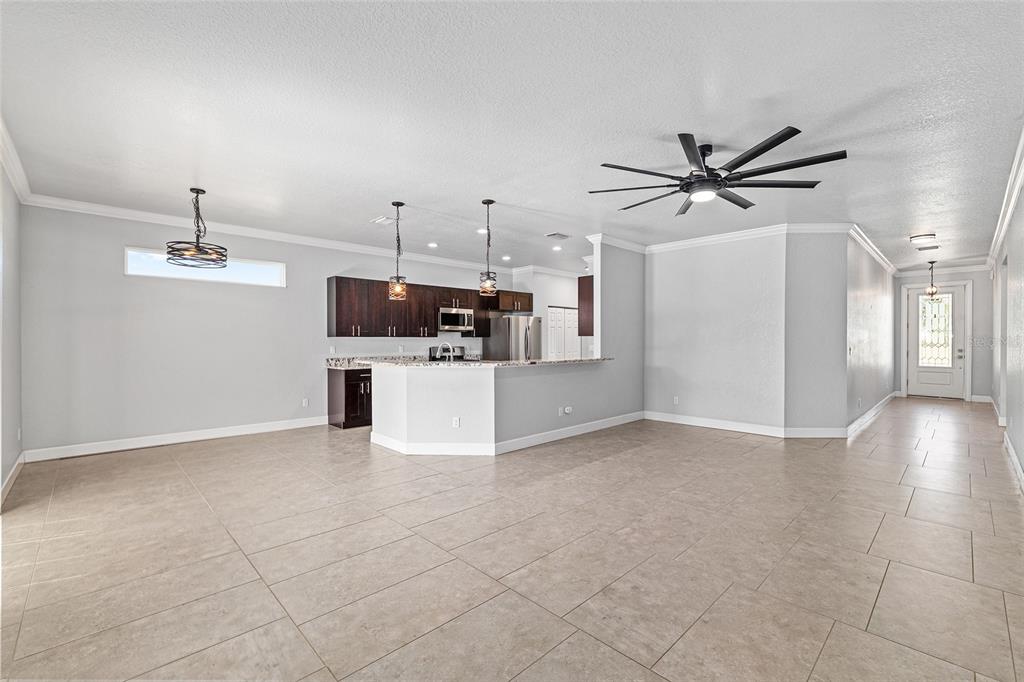 4765 Southeast 25th Street Ocala, FL 34480 - Photo 13 of 65 a view of a kitchen with a sink and a refrigerator
