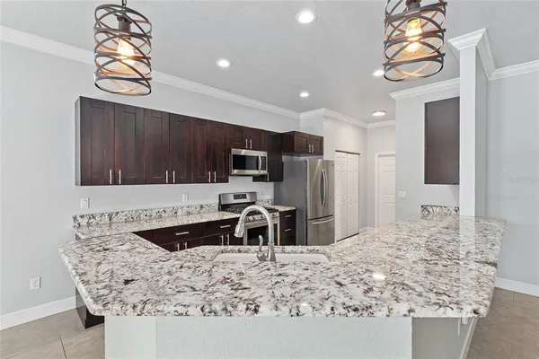 a kitchen with stainless steel appliances a stove a microwave sink and cabinets