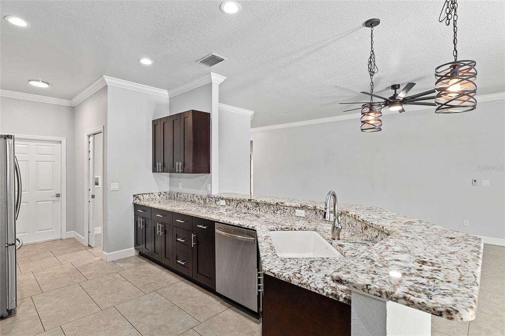 4765 Southeast 25th Street Ocala, FL 34480 - Photo 18 of 65 a bathroom with a granite countertop sink a large mirror and shower