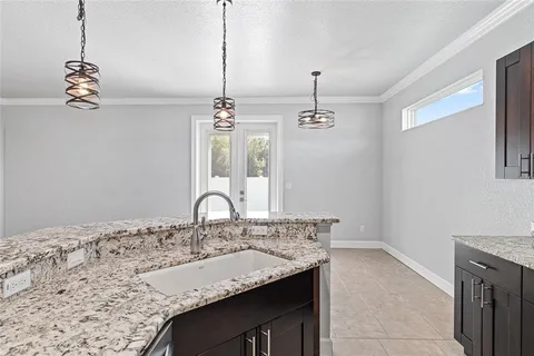 a large kitchen with granite countertop a sink and dishwasher