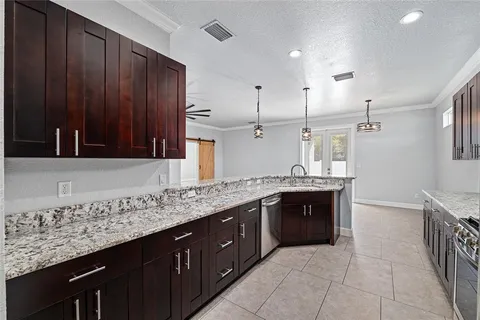 an empty room with windows and ceiling fan