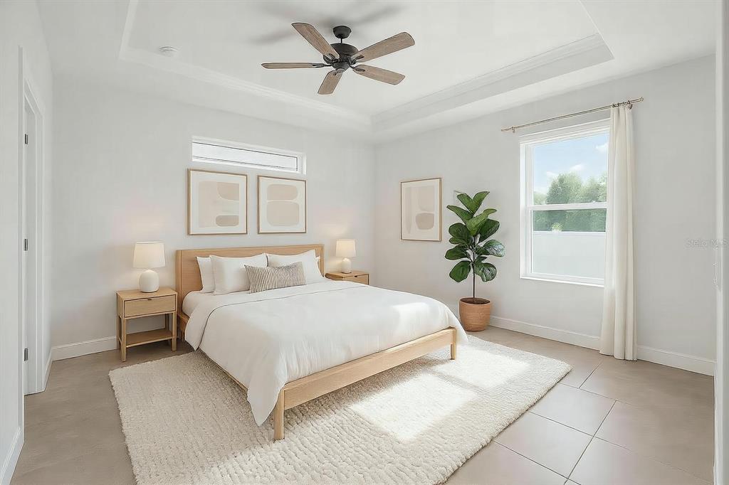 4765 Southeast 25th Street Ocala, FL 34480 - Photo 28 of 65 a bedroom with a large bed and a chandelier
