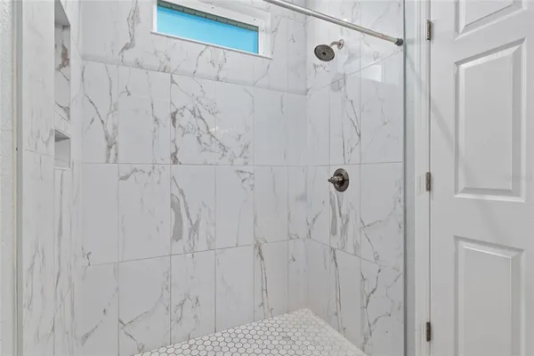 a bathroom with a bathtub and shower