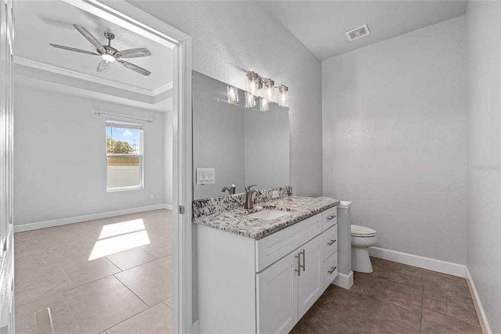 4765 Southeast 25th Street Ocala, FL 34480 - Photo 32 of 65 a bathroom with a sink toilet and mirror