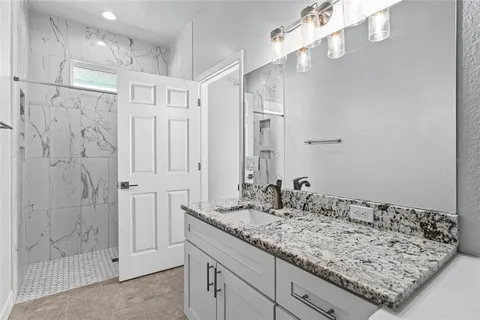 a bathroom with a bathtub and shower