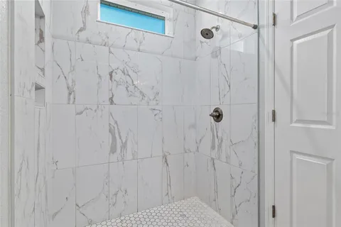 a view of an empty room with a ceiling fan