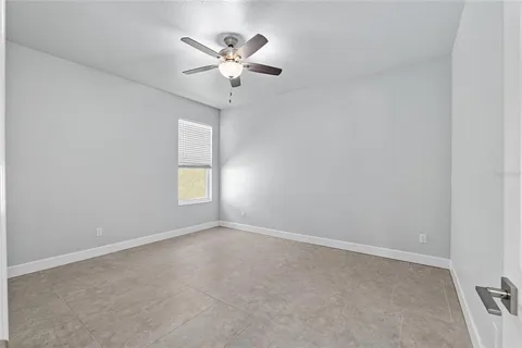 a view of a hallway with wooden floor and a living room