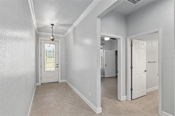 a view of an empty room with a ceiling fan