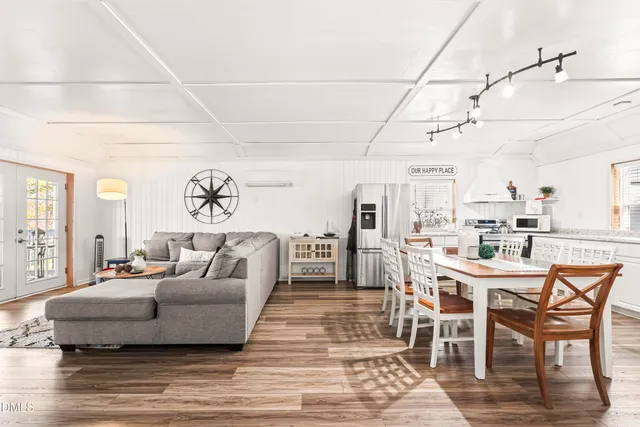 a spacious bathroom with a double vanity sink a mirror and a shower