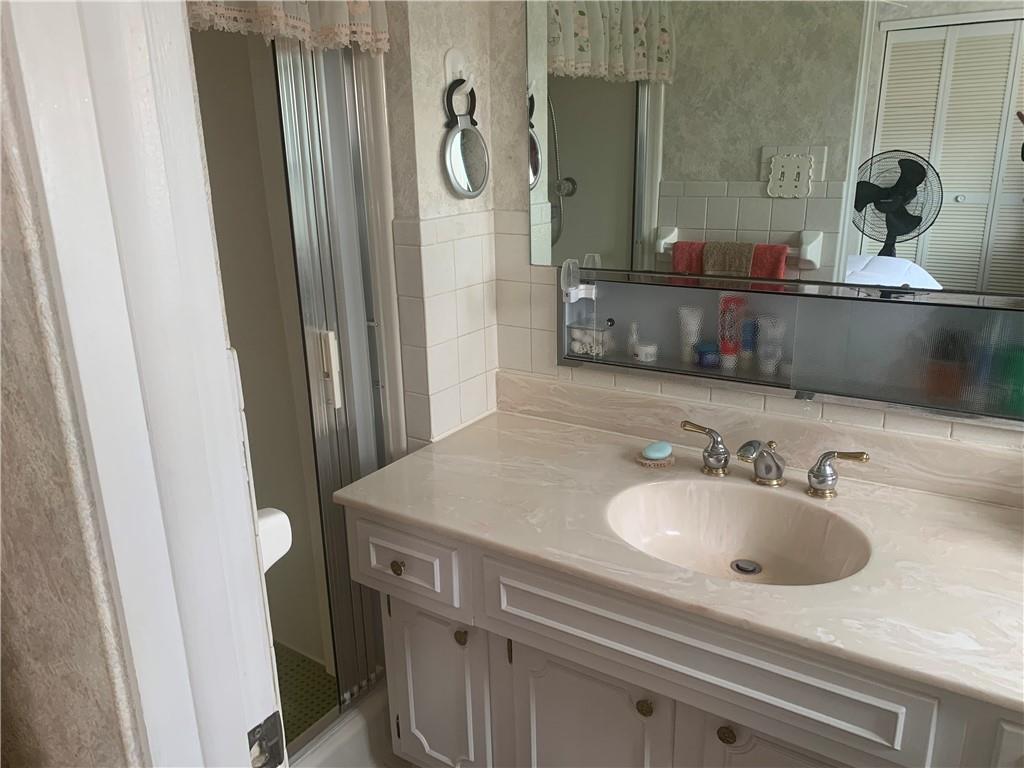 2404 Old Butler Road New Castle, PA 16101 - Photo 15 of 17 a bathroom with a sink and a mirror