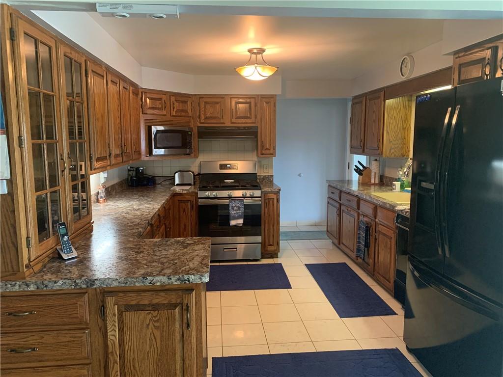 2404 Old Butler Road New Castle, PA 16101 - Photo 6 of 17 a kitchen with stainless steel appliances a stove a sink and a refrigerator