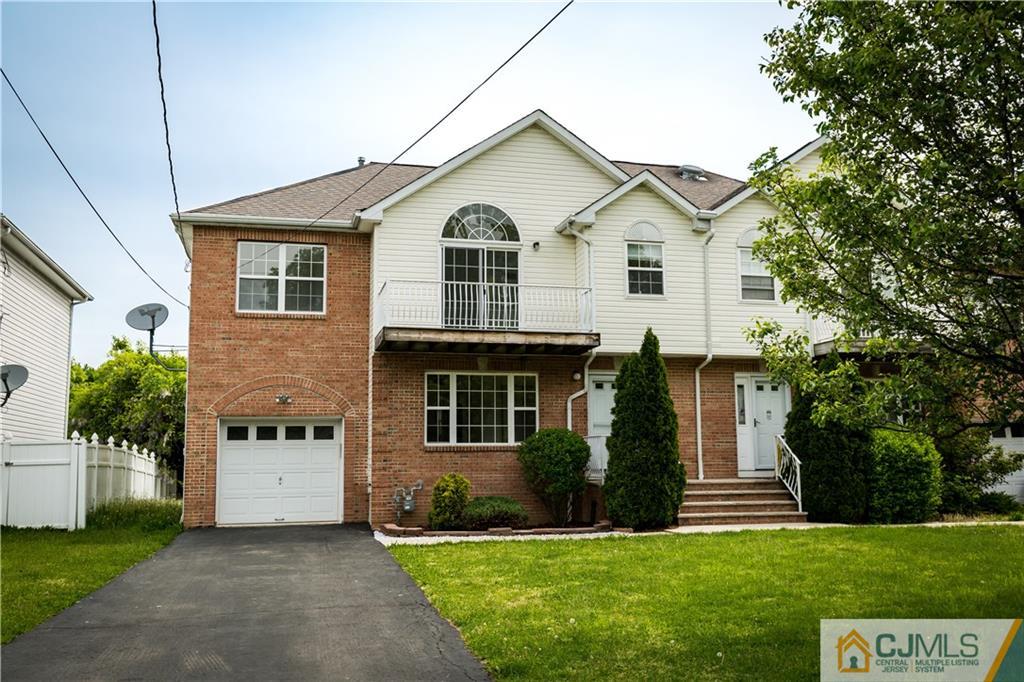 987 Cox Road North Brunswick, NJ 08902 - Photo 1 of 25 a front view of a house with a yard and garage