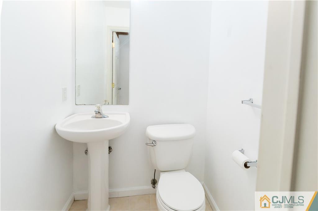 987 Cox Road North Brunswick, NJ 08902 - Photo 11 of 25 a bathroom with a sink toilet and a mirror