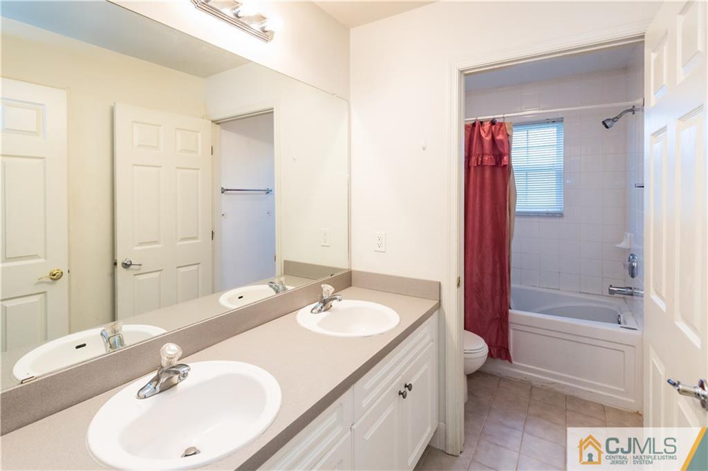 987 Cox Road North Brunswick, NJ 08902 - Photo 14 of 25 a bathroom with a sink and a mirror