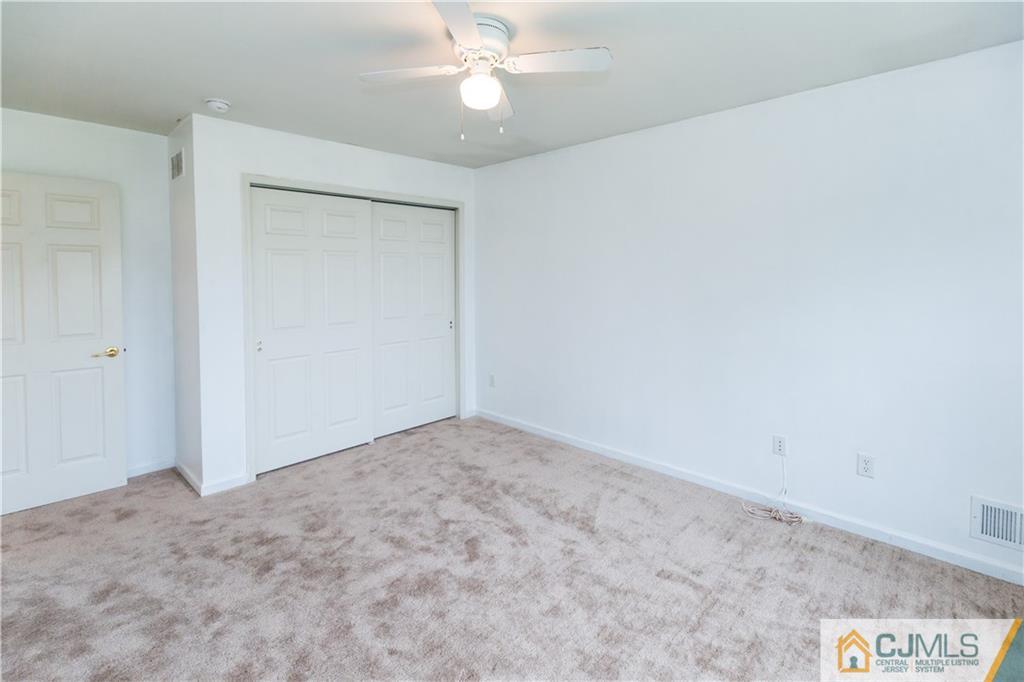 987 Cox Road North Brunswick, NJ 08902 - Photo 17 of 25 an empty room with a fan & a ceiling fan