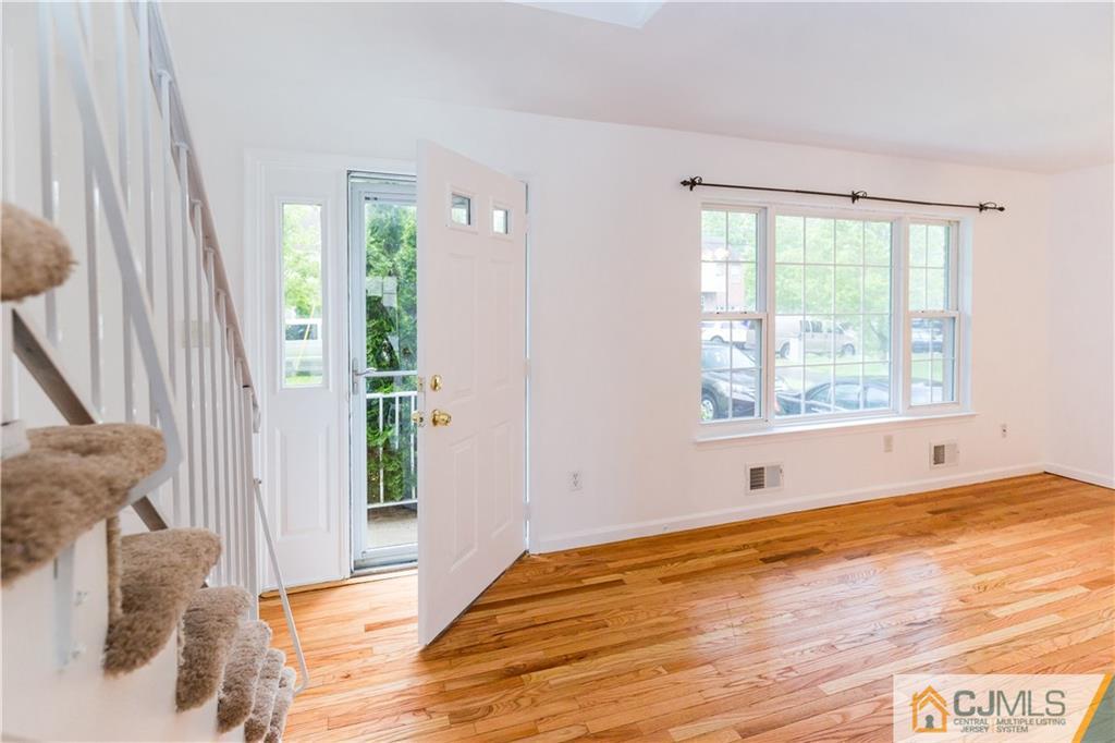 987 Cox Road North Brunswick, NJ 08902 - Photo 3 of 25 a view of an empty room with window and wooden floor