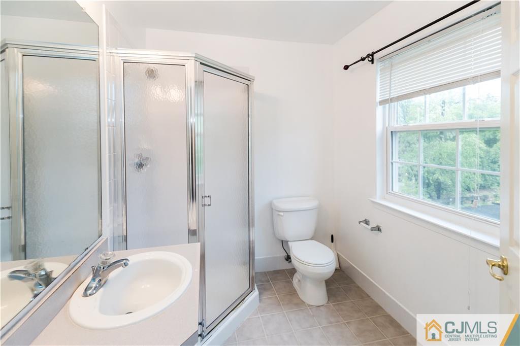 987 Cox Road North Brunswick, NJ 08902 - Photo 22 of 25 a bathroom with a sink toilet and shower