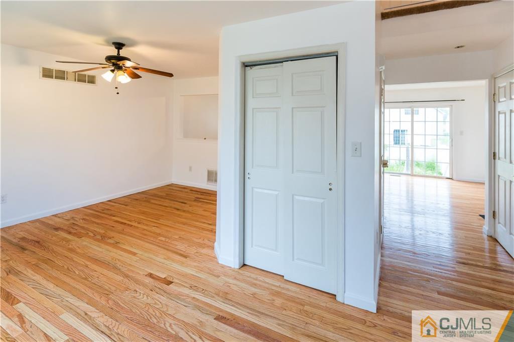987 Cox Road North Brunswick, NJ 08902 - Photo 5 of 25 wooden floor in an empty room with a window