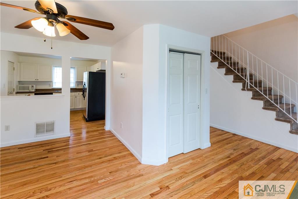 987 Cox Road North Brunswick, NJ 08902 - Photo 6 of 25 a view of a hallway with wooden floor and staircase