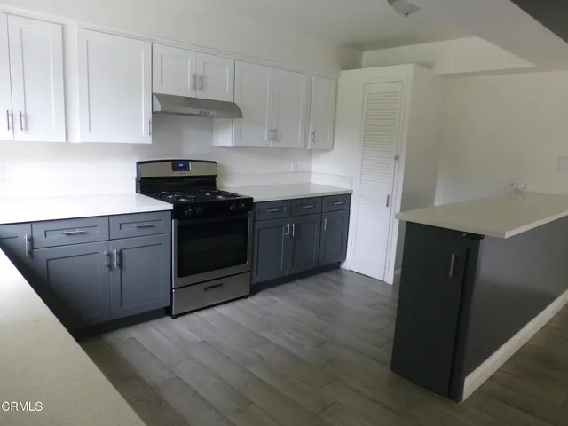 a kitchen with stainless steel appliances granite countertop a stove and a refrigerator