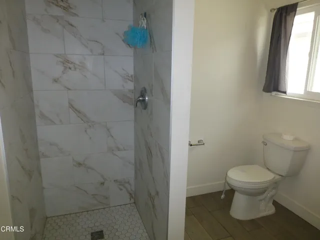 a white toilet sitting next to a bathroom sink