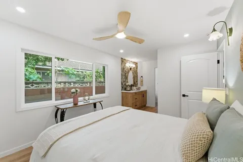 a bedroom with a bed and a large window