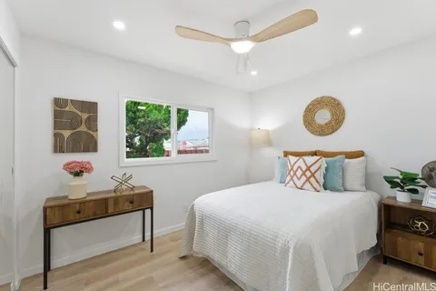 a bedroom with a bed and a window