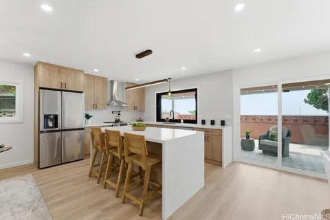 a kitchen with a table chairs refrigerator and microwave