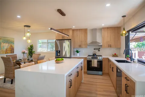 a kitchen with a sink stove and cabinets