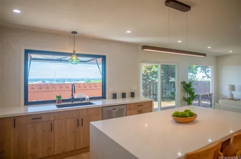 a kitchen with stainless steel appliances a sink a counter space and a window