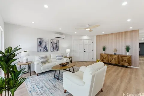 a living room with furniture and a wooden floor