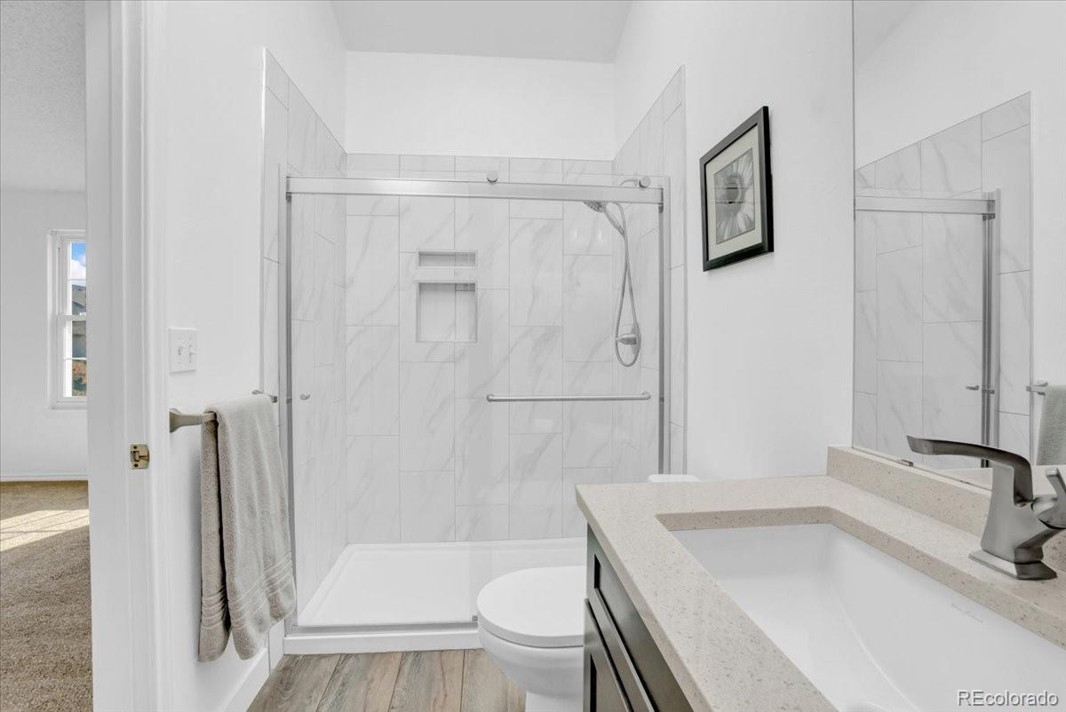3066 West Prentice Avenue, Unit G Littleton, CO 80123 - Photo 13 of 18 a bathroom with a sink a toilet and shower