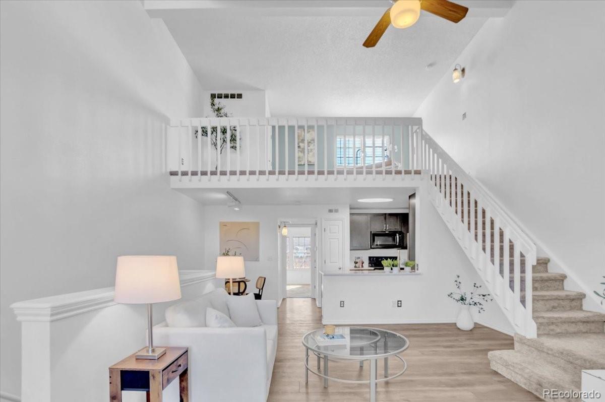 3066 West Prentice Avenue, Unit G Littleton, CO 80123 - Photo 2 of 18 a living room with furniture and a wooden floor