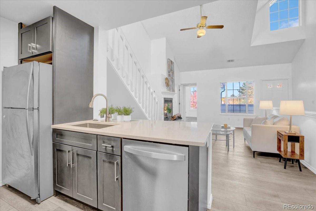 3066 West Prentice Avenue, Unit G Littleton, CO 80123 - Photo 7 of 18 a kitchen with stainless steel appliances granite countertop a table and chairs
